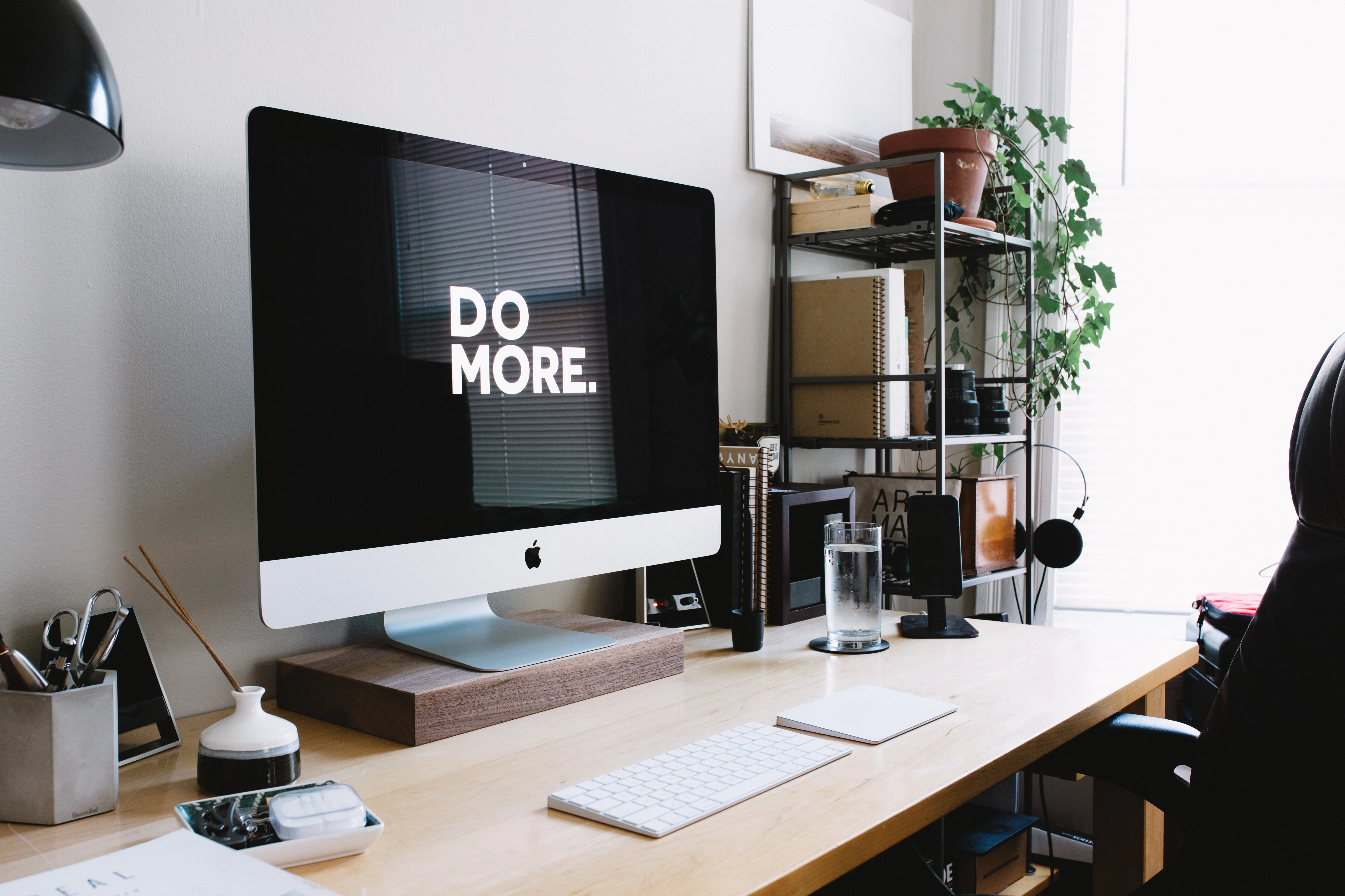 Desk with computer saying 'Do More' by Carl Heyerdahl on Unsplash