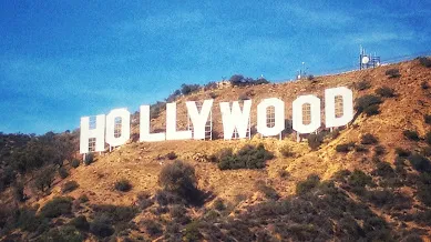 The Hollywood sign in the hills on a sunny day.