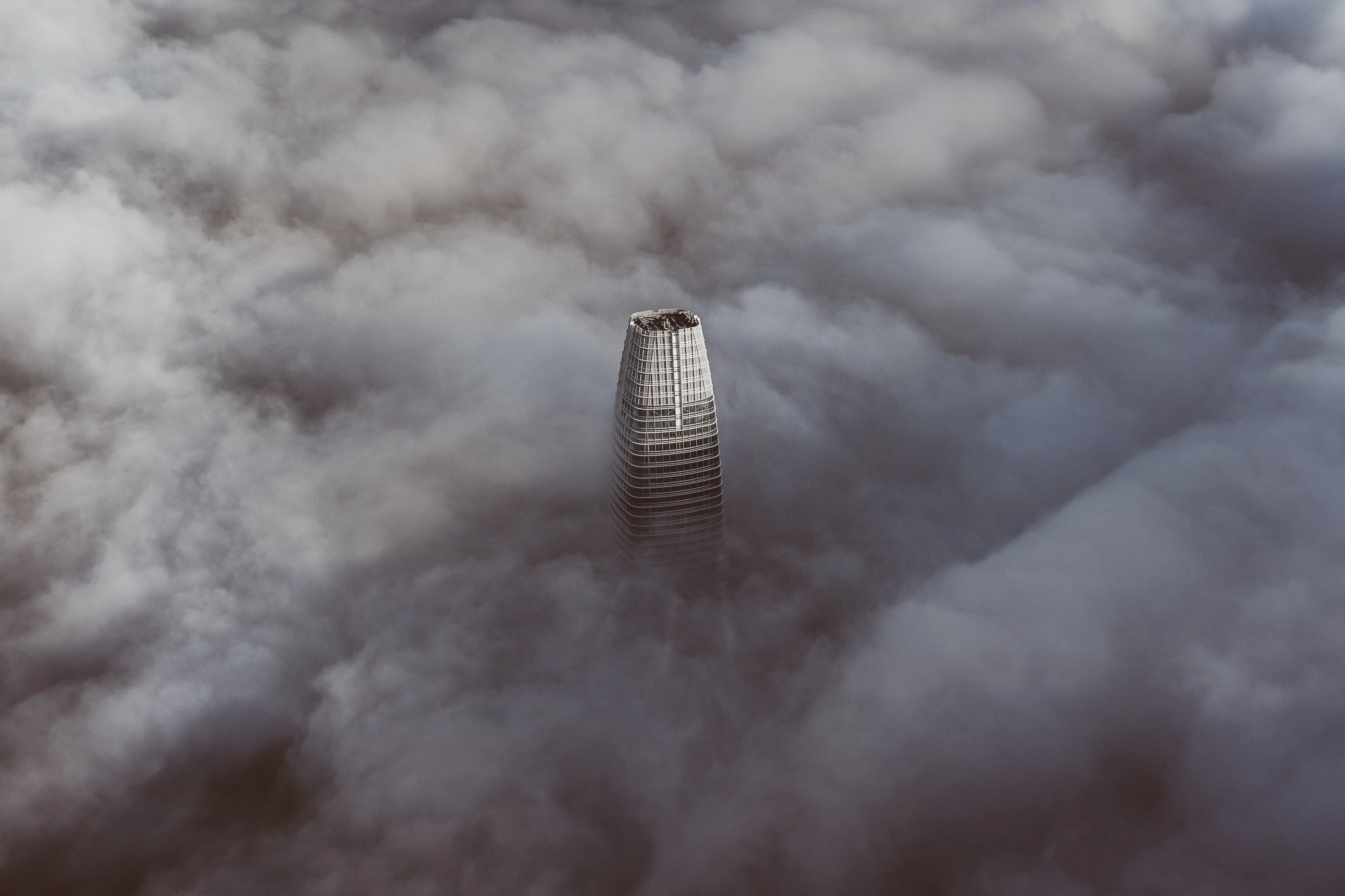 Salesforce tower piercing through the clouds by Denys Nevozhai on Unsplash